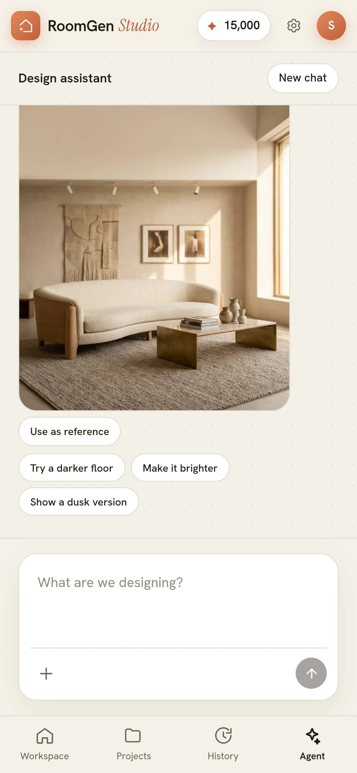 The Design assistant thread with a New chat button in its header, a finished render of a warm oak living room with a curved cream sofa and a brass coffee table filling most of the width, a Use as reference pill directly under it, then the suggestion pills Try a darker floor, Make it brighter and Show a dusk version, above a prompt box reading What are we designing?