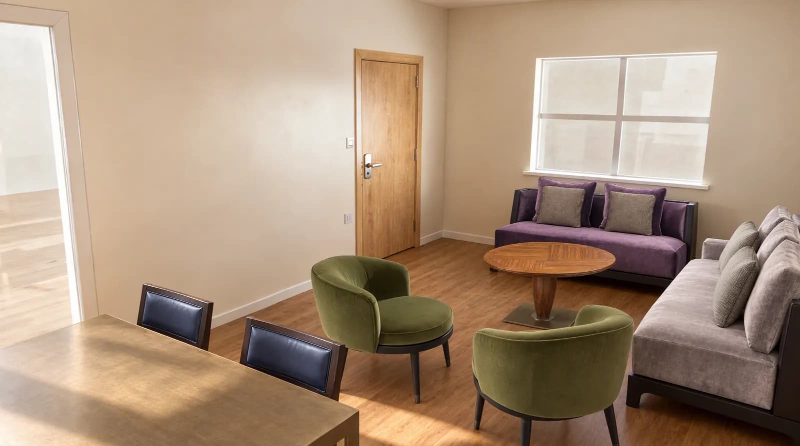 The open-plan room rendered: a dining table and two navy chairs in front, two green armchairs around a round wood table, and two sofas by the window